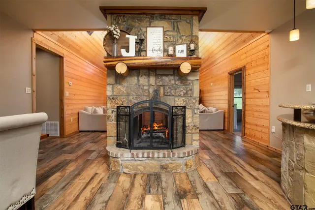 a large kitchen with granite countertop a large window cabinets and stainless steel appliances