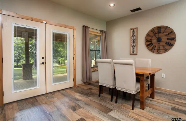 a kitchen with stainless steel appliances granite countertop a sink a stove and a wooden floors