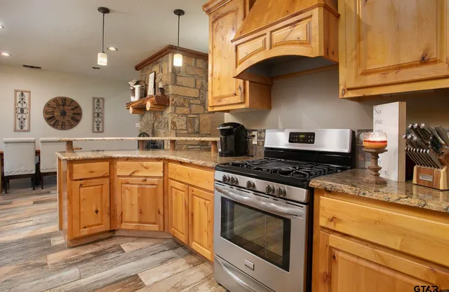 a kitchen with granite countertop a stove and a sink