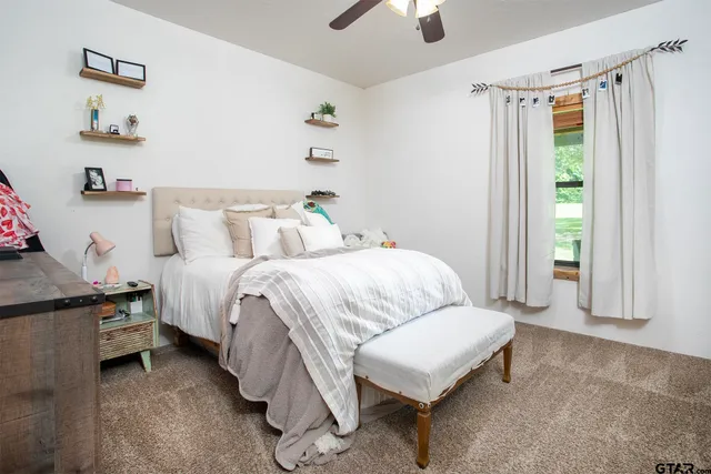 a bathroom with a granite countertop toilet sink and mirror