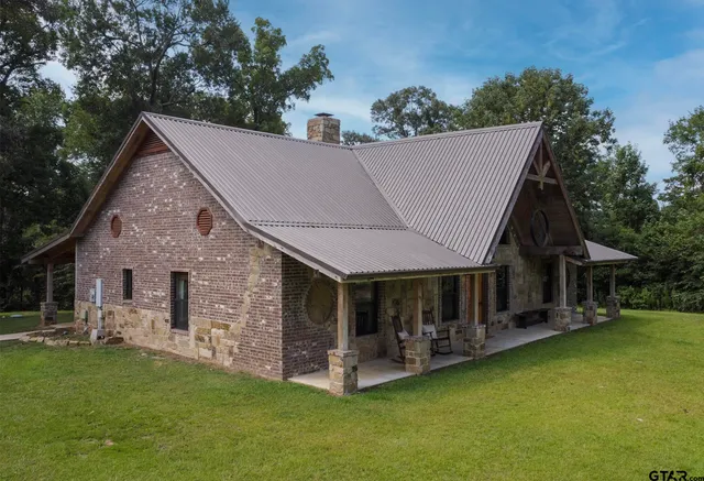 a aerial view of a house with swimming pool next to a yard