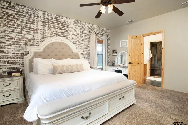 a bathroom with a granite countertop sink a large mirror and a