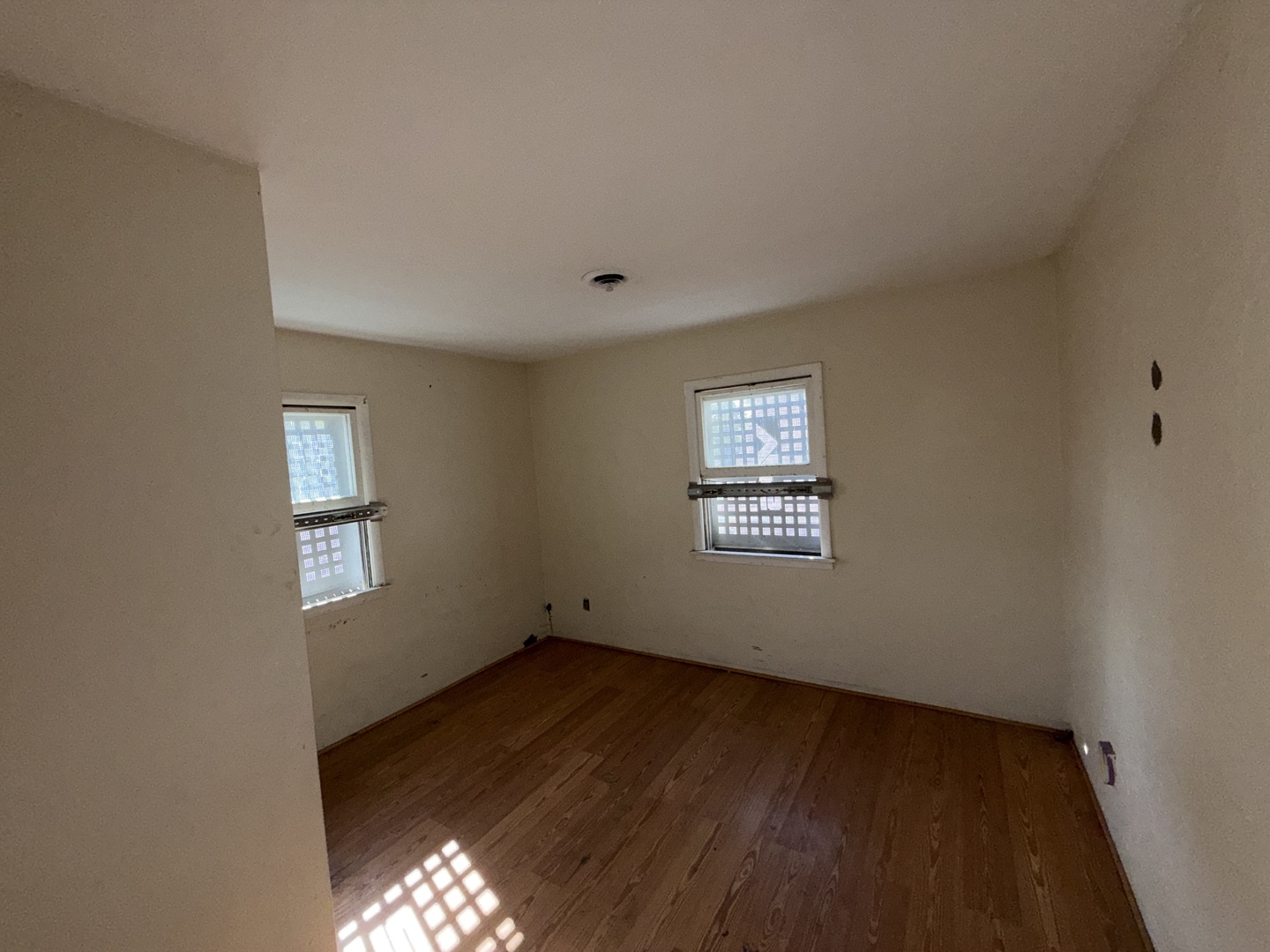 962 Oliver Avenue Aurora, IL 60506 - Photo 15 of 17 a view of an empty room with wooden floor and a window