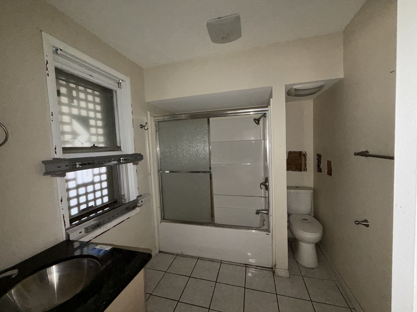 962 Oliver Avenue Aurora, IL 60506 - Photo 9 of 17 a bathroom with a toilet a shower and a sink