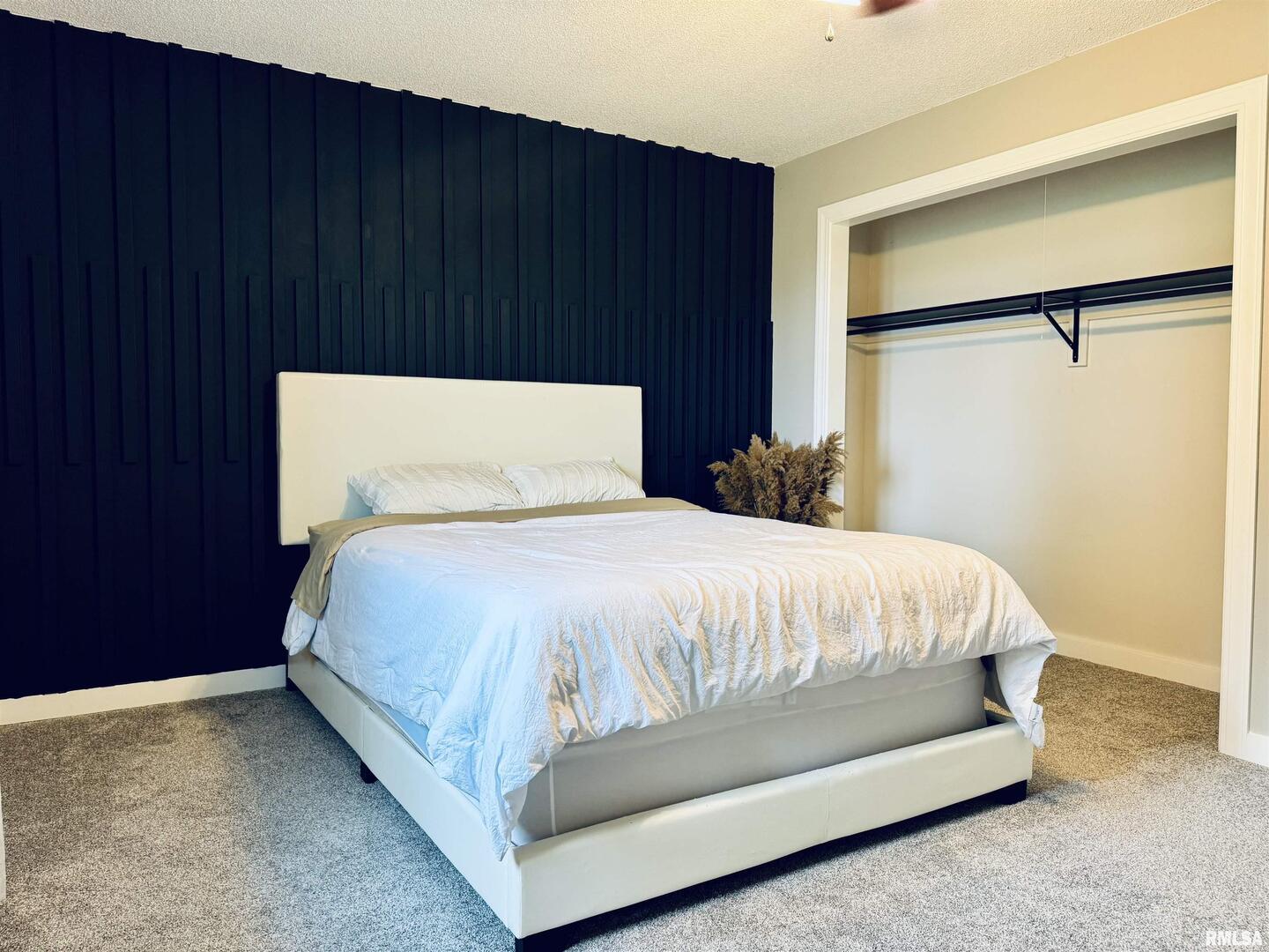 708 Tower Road Clinton, IA 52732 - Photo 15 of 34 a bed sitting in a bedroom next to a wooden door