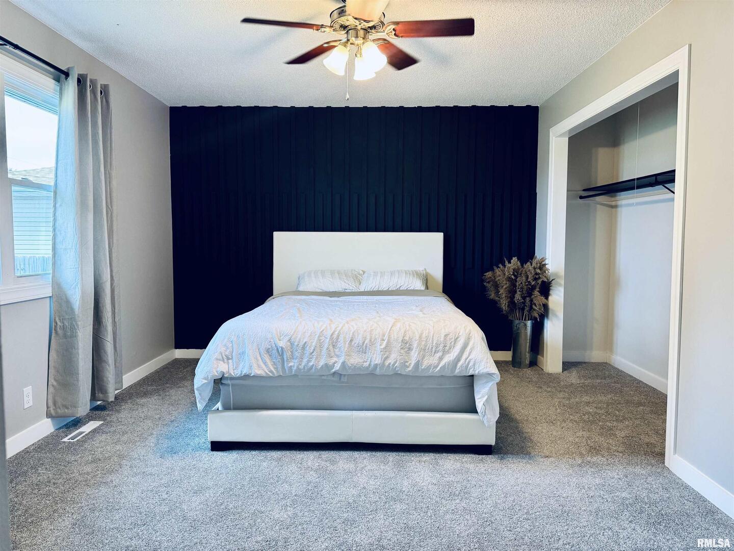 708 Tower Road Clinton, IA 52732 - Photo 16 of 34 a bedroom with a bed and a ceiling fan