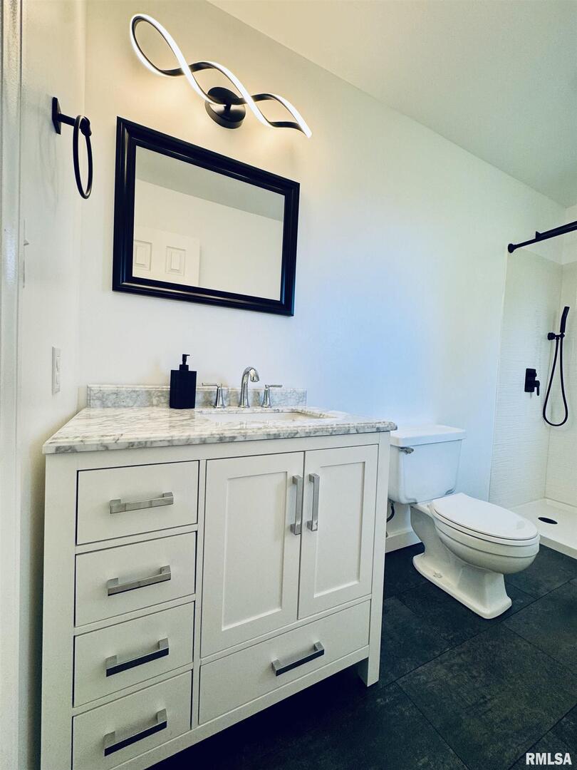 708 Tower Road Clinton, IA 52732 - Photo 19 of 34 a bathroom with a toilet sink and mirror