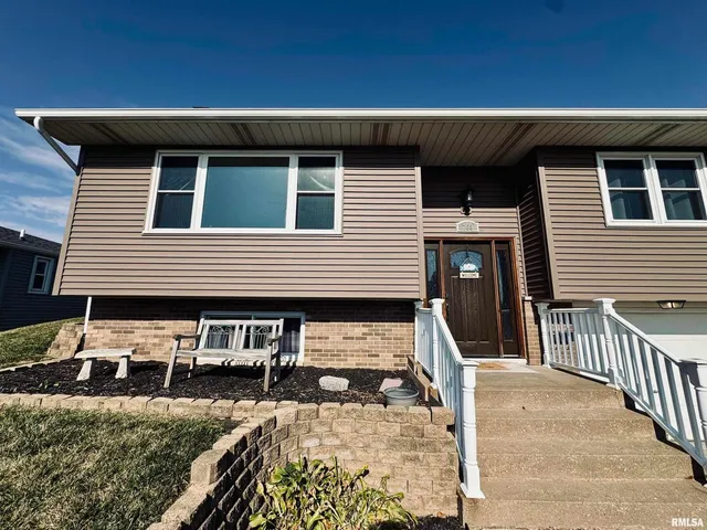 a view of a house with wooden fence