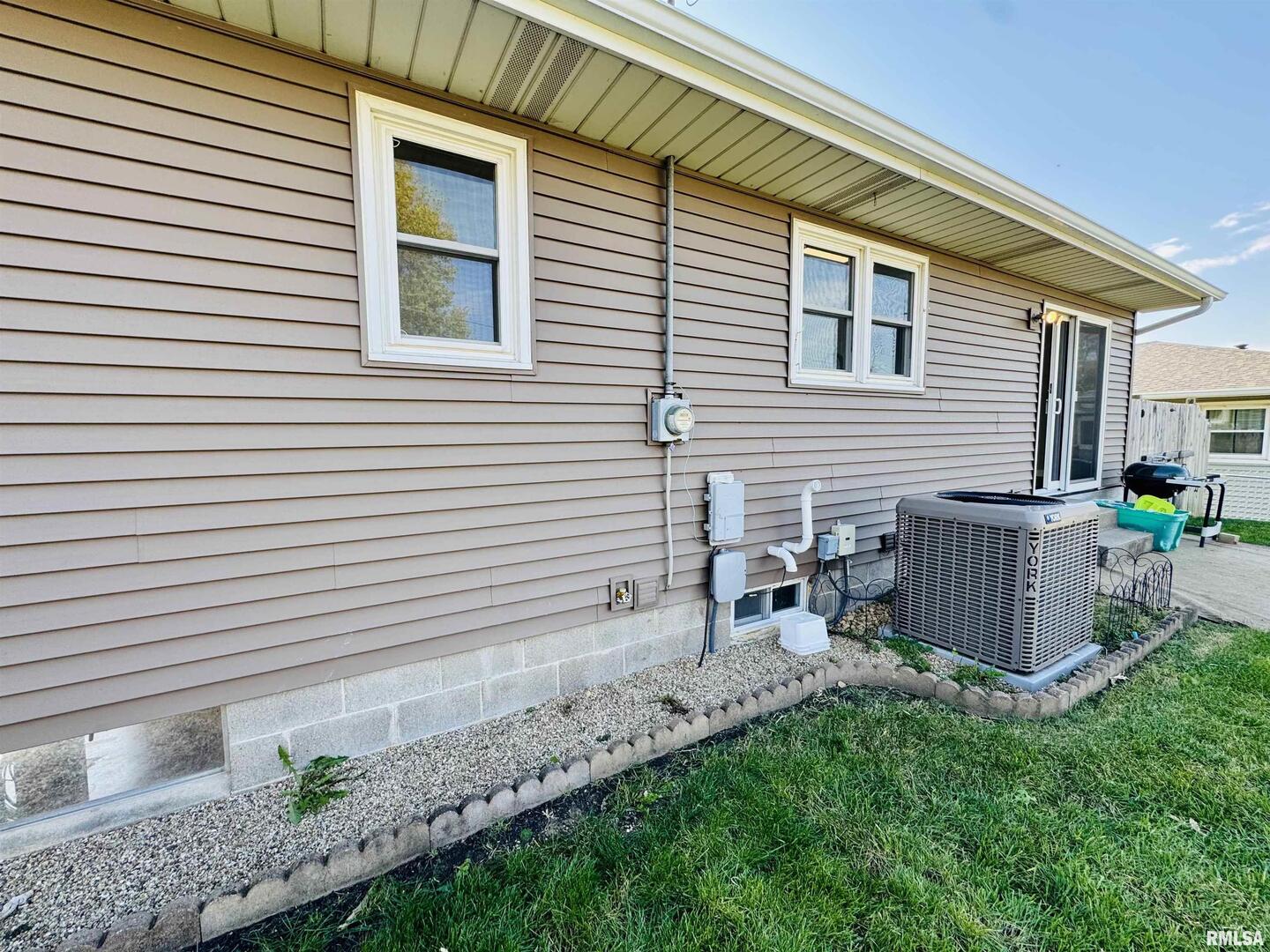 708 Tower Road Clinton, IA 52732 - Photo 32 of 34 a view of backyard with a chair and table in the patio