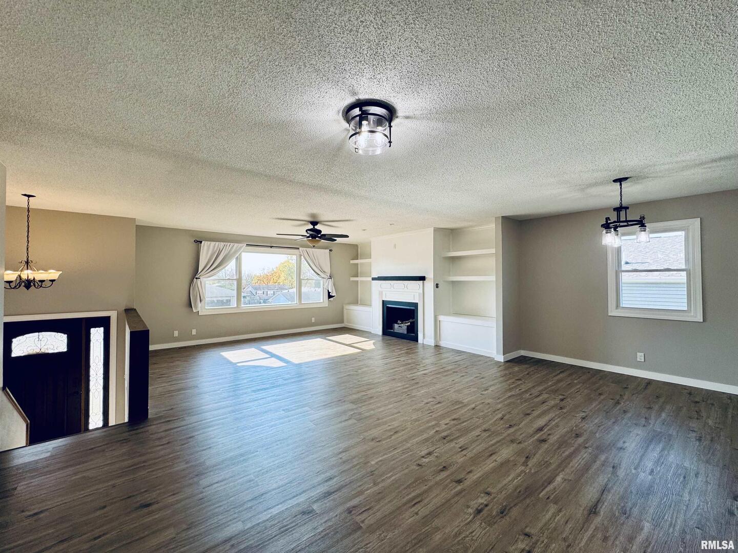 708 Tower Road Clinton, IA 52732 - Photo 7 of 34 a view of empty room with wooden floor and fireplace