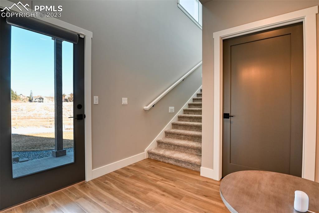 14149 Stone Eagle Place Colorado Springs, CO 80921 - Photo 19 of 47 a view of a hallway with wooden floor and entryway