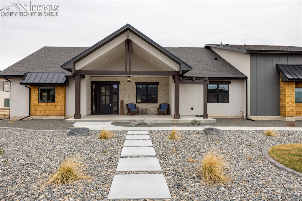 14149 Stone Eagle Place Colorado Springs, CO 80921 - Photo 2 of 47 a front view of a house with a yard and garage
