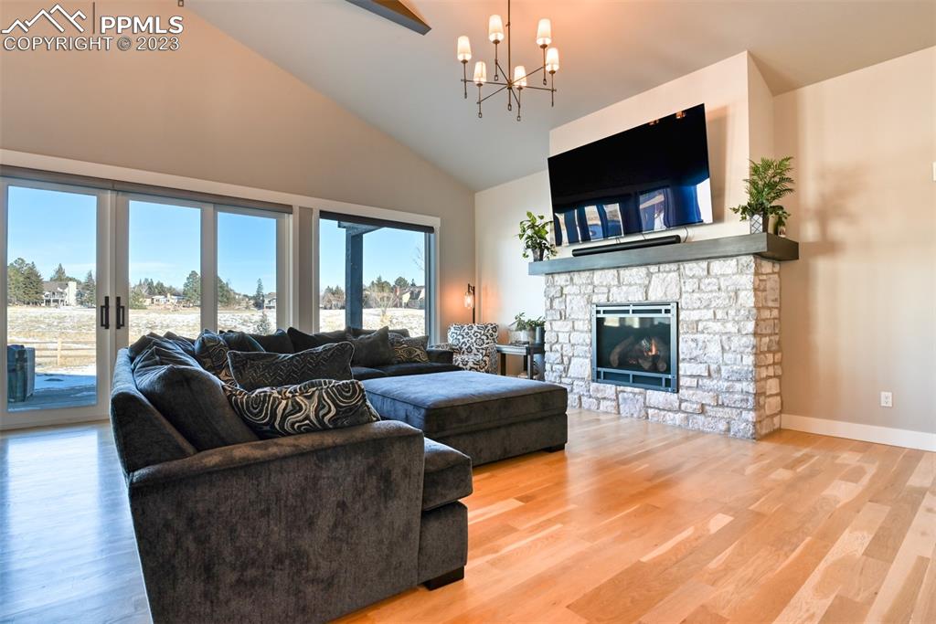 14149 Stone Eagle Place Colorado Springs, CO 80921 - Photo 25 of 47 a living room with fireplace furniture and a flat screen tv