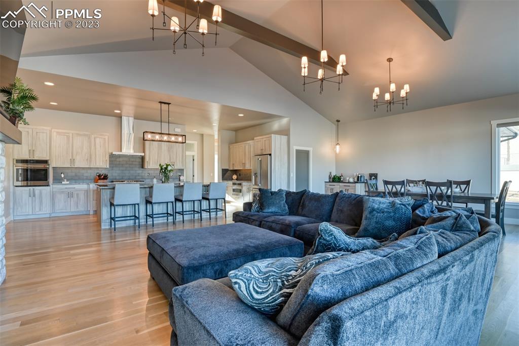 14149 Stone Eagle Place Colorado Springs, CO 80921 - Photo 28 of 47 a living room with lots of furniture and a chandelier