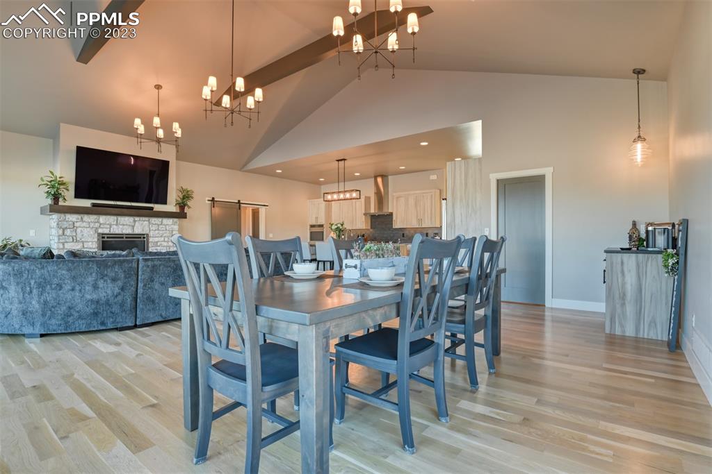 14149 Stone Eagle Place Colorado Springs, CO 80921 - Photo 30 of 47 a view of a dining room with furniture and wooden floor