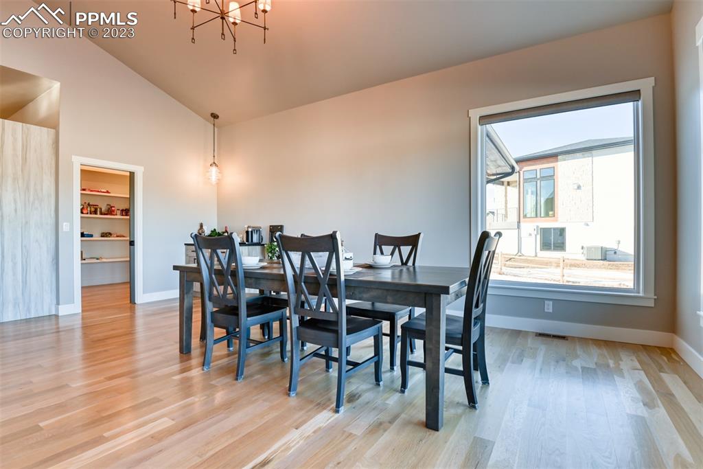 14149 Stone Eagle Place Colorado Springs, CO 80921 - Photo 31 of 47 a view of a dining room with furniture window and wooden floor
