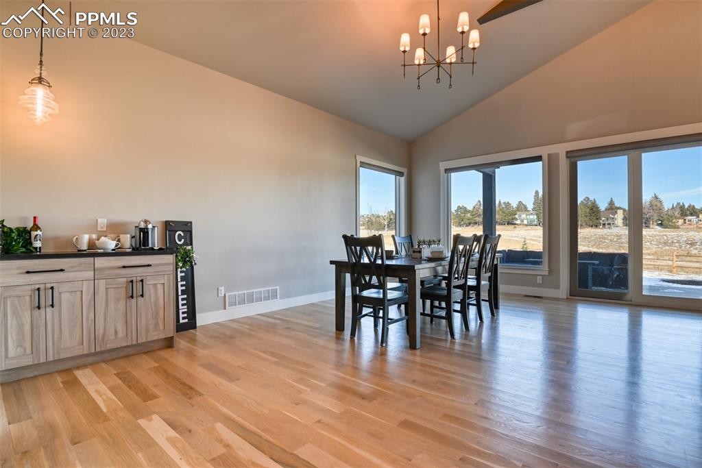14149 Stone Eagle Place Colorado Springs, CO 80921 - Photo 32 of 47 a view of a dining room with furniture window and wooden floor