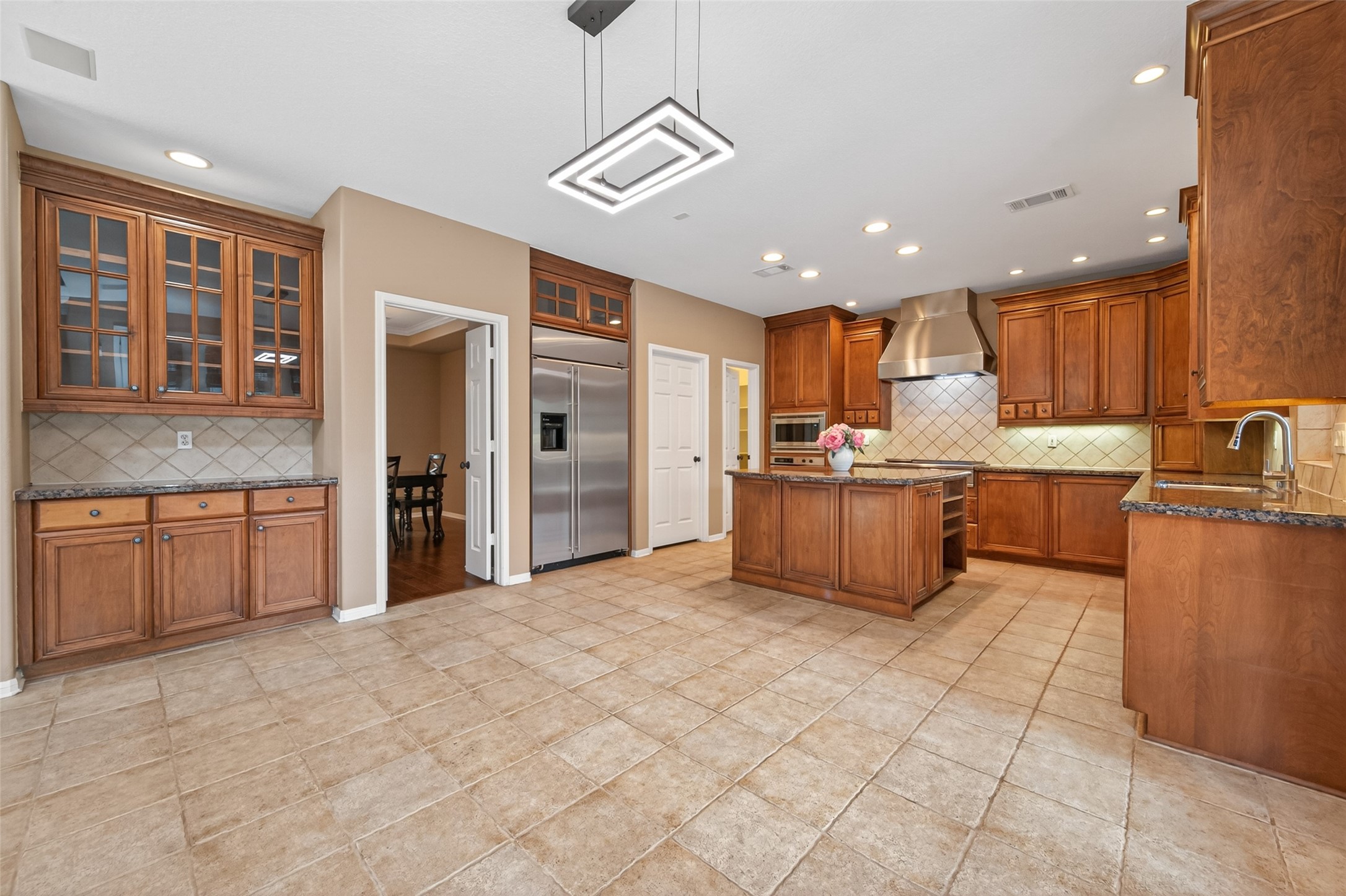 10 Mirror Ridge Drive The Woodlands, TX 77382 - Photo 13 of 48 The kitchen flows seamlessly into the breakfast area and living room, creating an ideal layout for entertaining and everyday family living