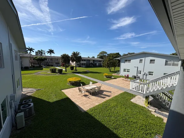 a view of a house with a yard and porch