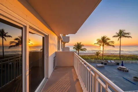 a view of a balcony with ocean view
