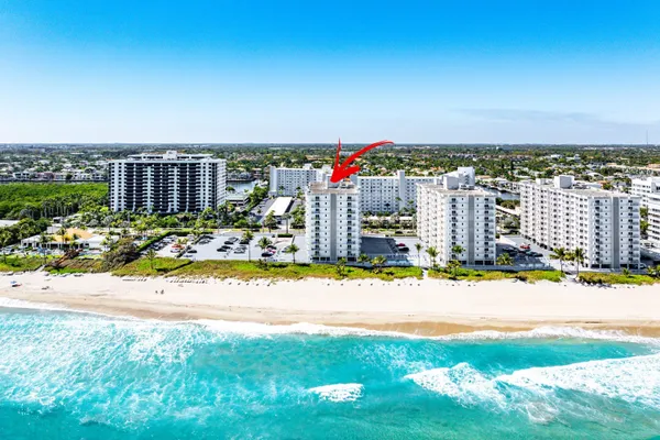 a room with pool table and windows