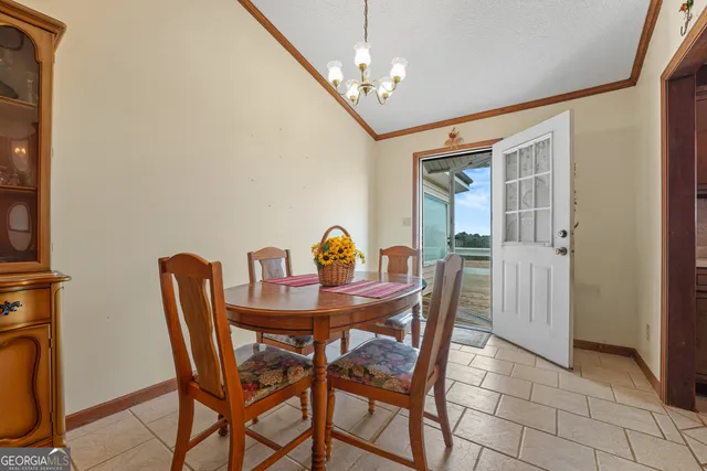 a view of a house with a barbeque and wooden stairs