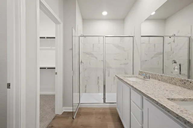 a bathroom with a granite countertop sink and mirror
