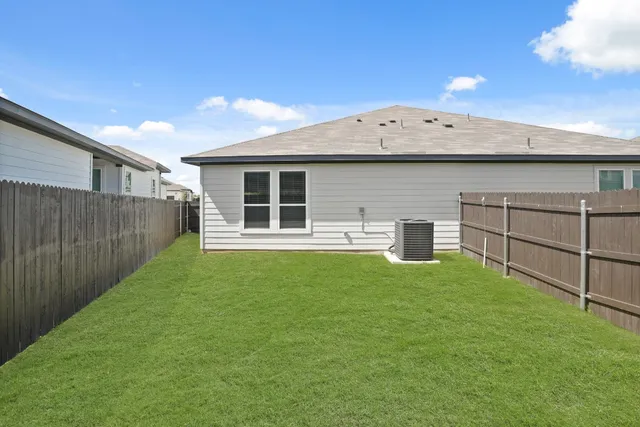 a view of a backyard with a wooden fence