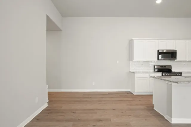 a view of a kitchen with microwave and cabinets