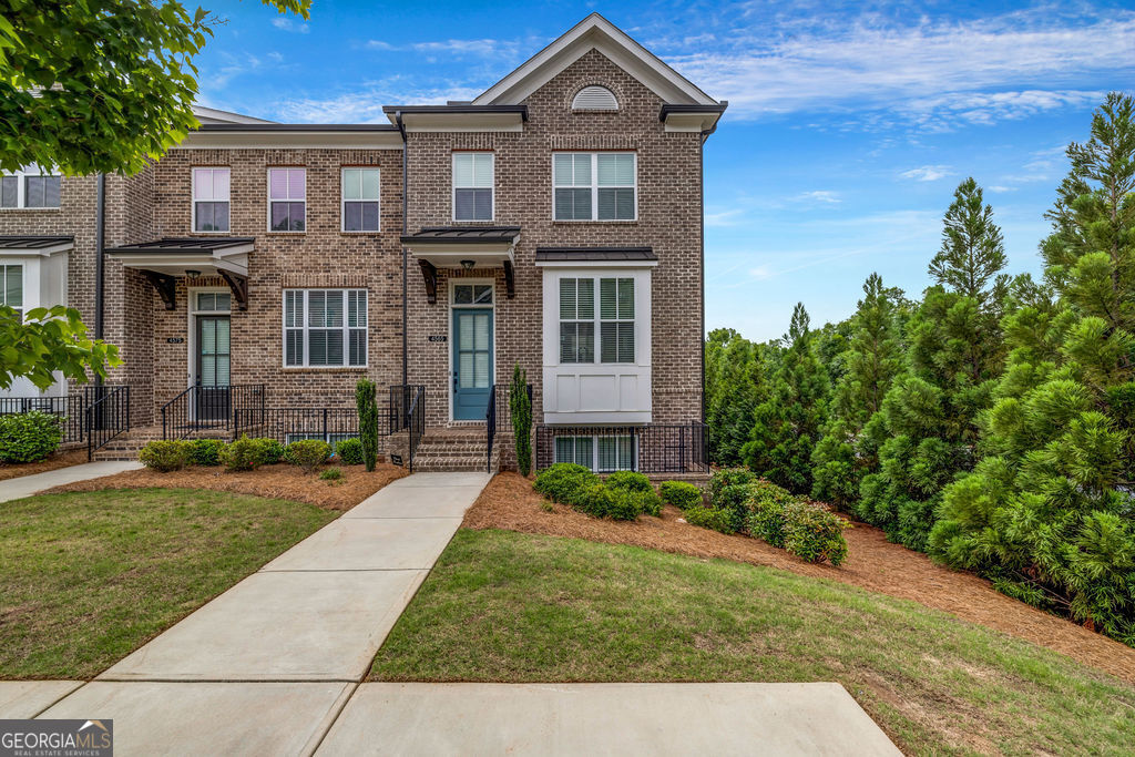 4565 Sims Park Pl. Park Suwanee, GA 30024 - Photo 1 of 1 a front view of a house with garden
