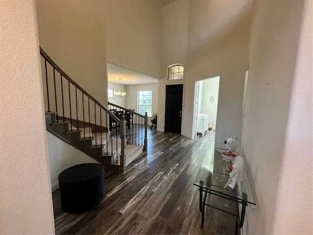 a view of entryway and hall with wooden floor