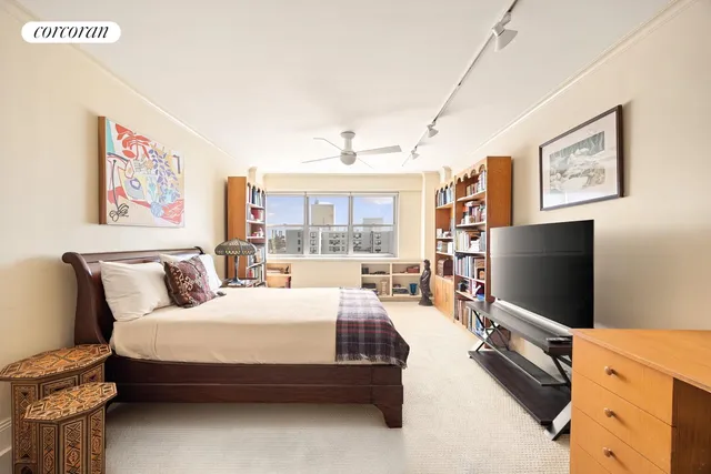 a bedroom with a bed and flat screen tv