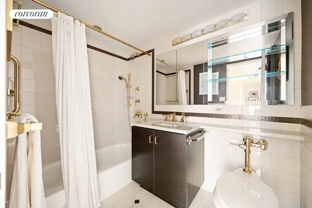 a bathroom with a sink a large mirror and a shower