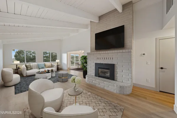 a living room with furniture fireplace and flat screen tv