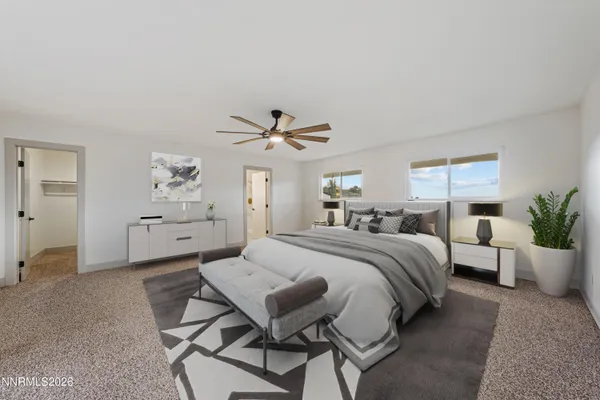 a spacious bedroom with a bed and a potted plant