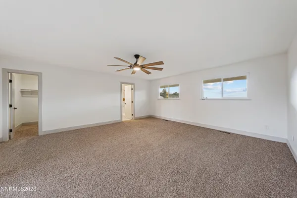 a view of a livingroom with a ceiling fan and window