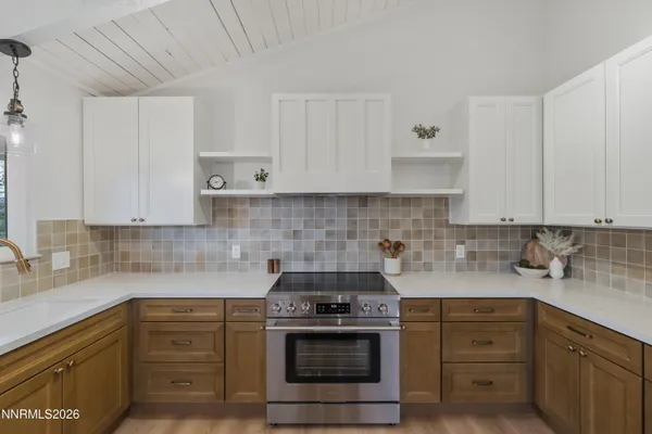 a kitchen with sink a stove and cabinets