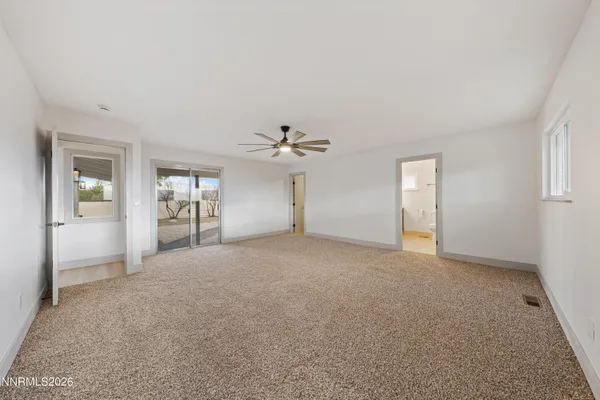 an empty room with windows and cabinet