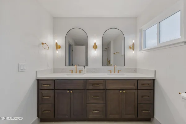 a bathroom with 2 sink and a mirror