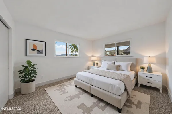 a bedroom with a bed and a potted plant