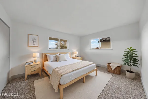 a bedroom with a bed and a couch