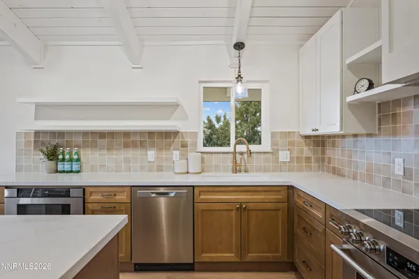 a kitchen with stainless steel appliances granite countertop a sink and a stove