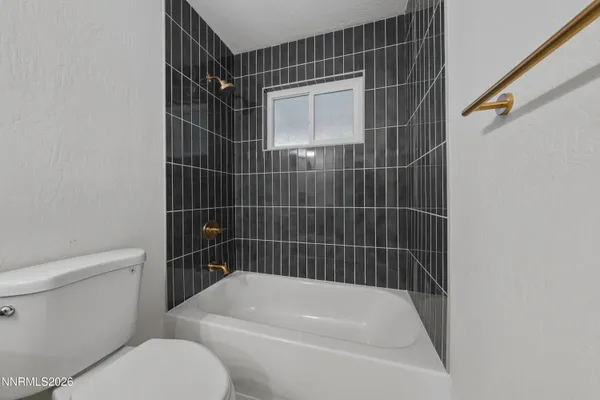 a bathroom with a toilet and a bathtub