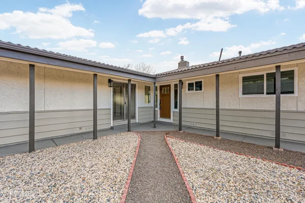 a view of a house with a backyard