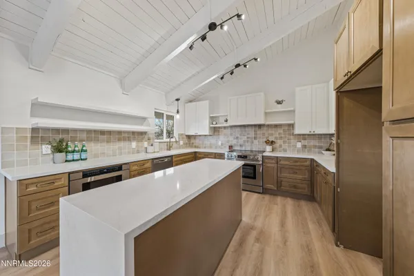 outdoor kitchen with stainless steel appliances granite countertop a lot of counter space and wooden floors