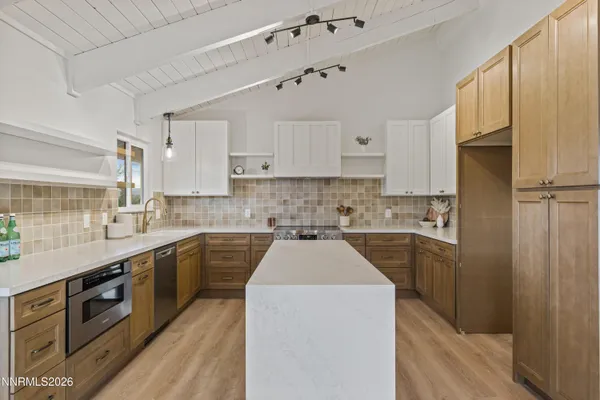 a kitchen with a sink a stove and refrigerator