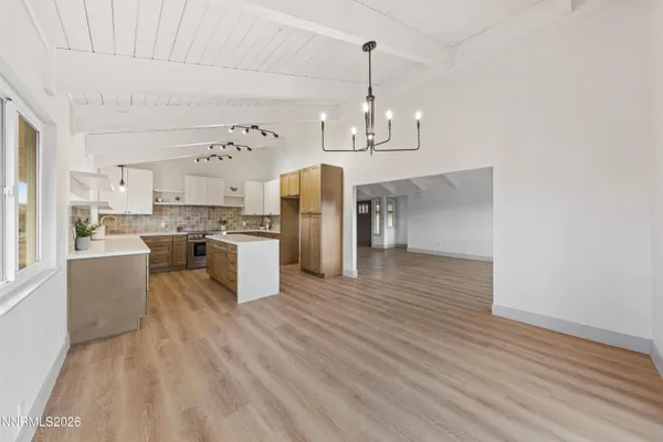 a open kitchen with stainless steel appliances granite countertop a stove and refrigerator