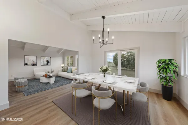 a view of a dining room with furniture wooden floor and chandelier