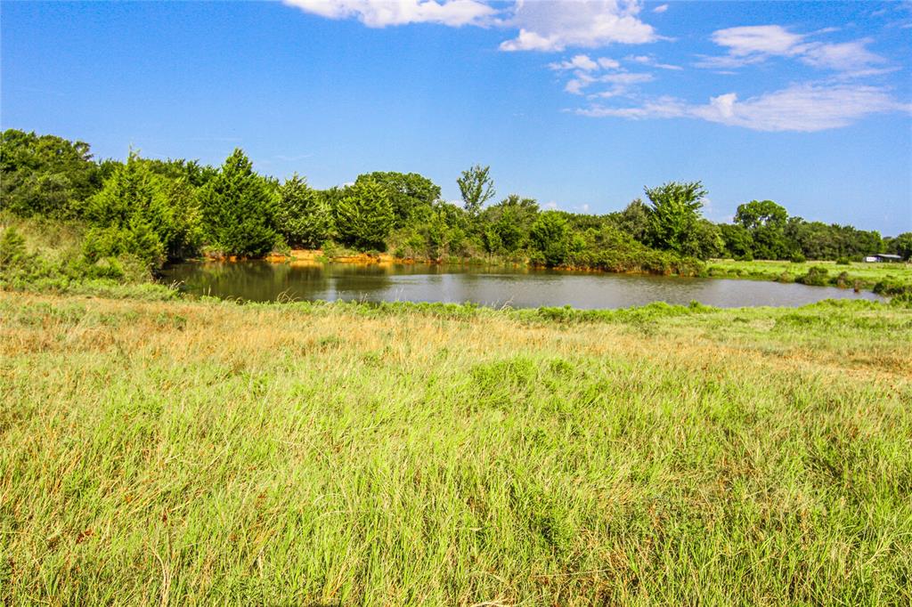 2215 Denver Road Sunset, TX 76270 - Photo 20 of 36 a view of a lake with a house in the background