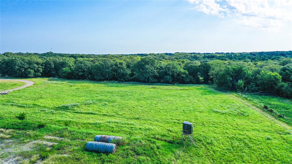 2215 Denver Road Sunset, TX 76270 - Photo 26 of 36 a backyard of a house with lots of green space and mountain view